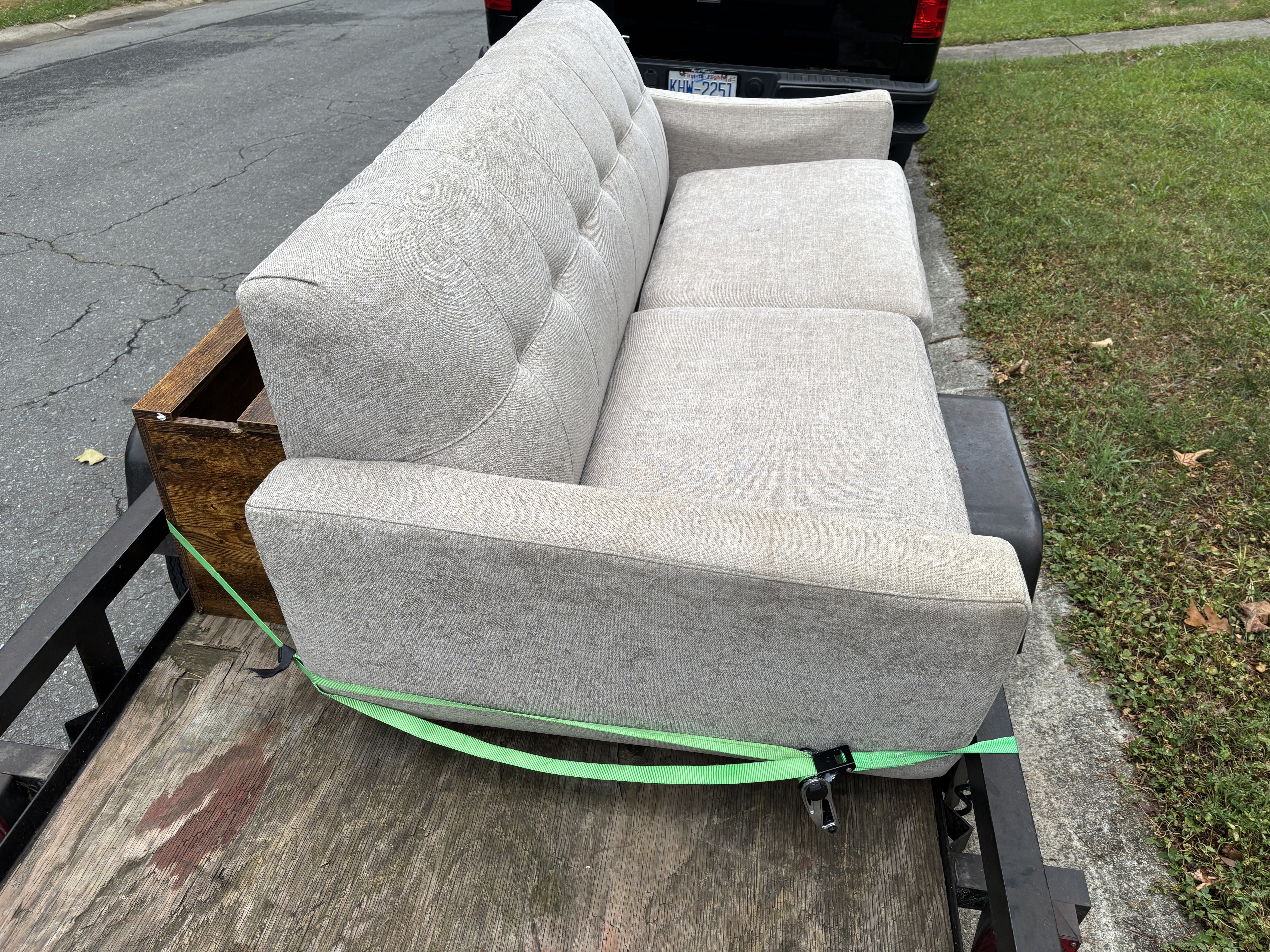 Lucky Services furniture removal - couch strapped to trailer in Charlotte NC