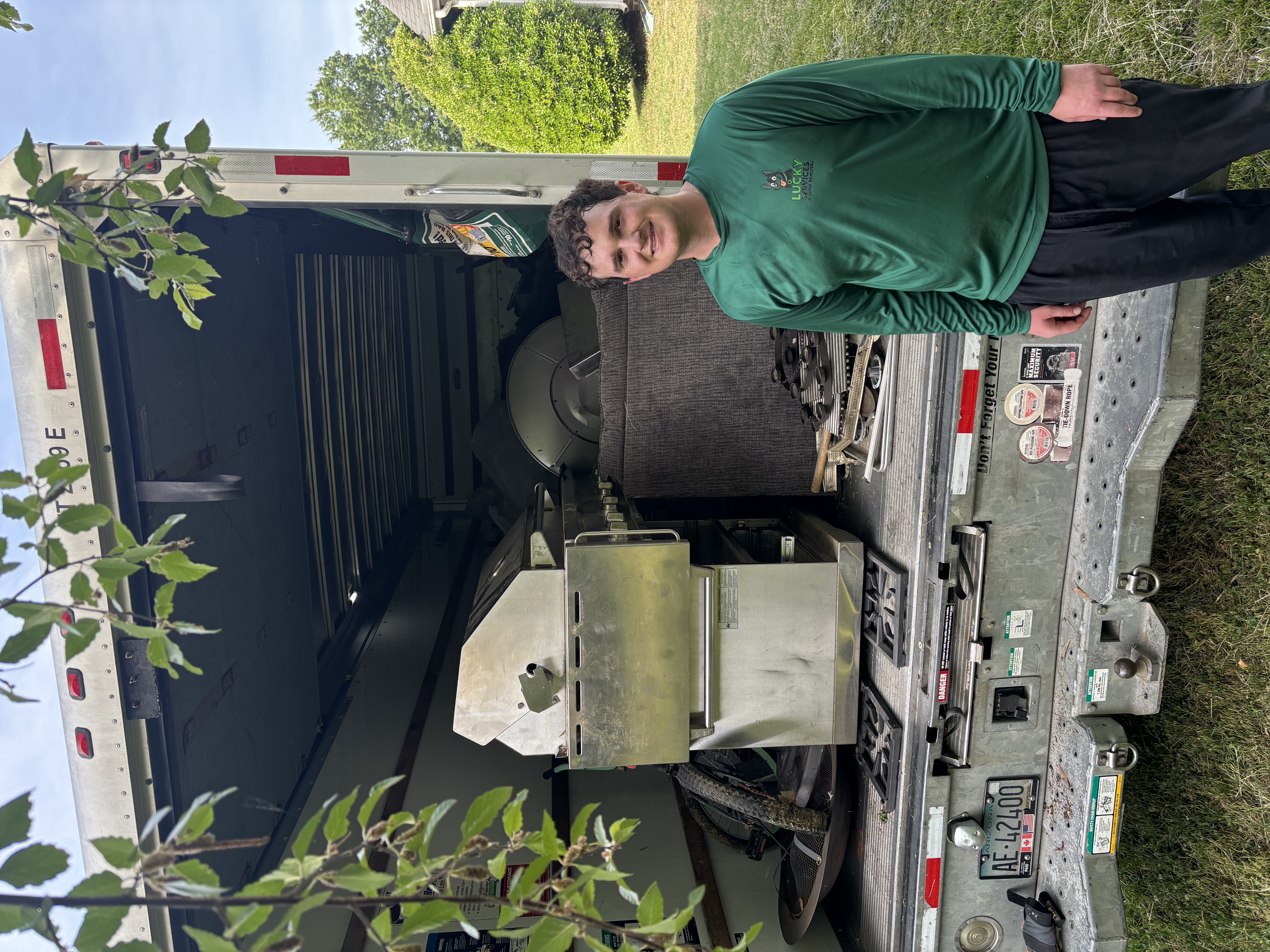 Carson from Lucky Services with loaded junk removal truck in Charlotte NC